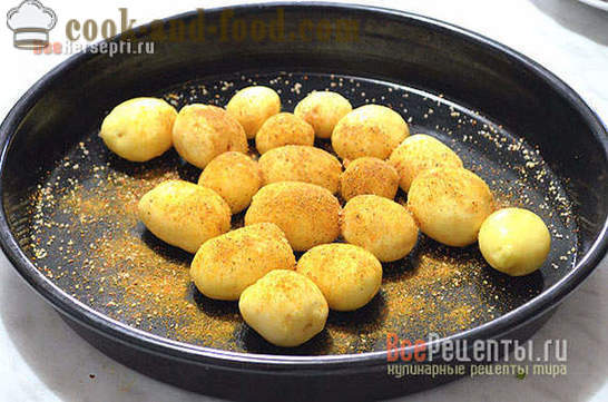 Benen van de kip met aardappelen in de oven